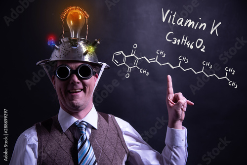 Nerd presenting handdrawn chemical formula of Vitamin K