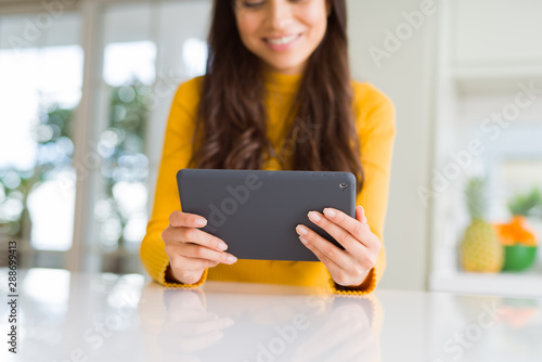 Beautiful young woman working using touchpad tablet