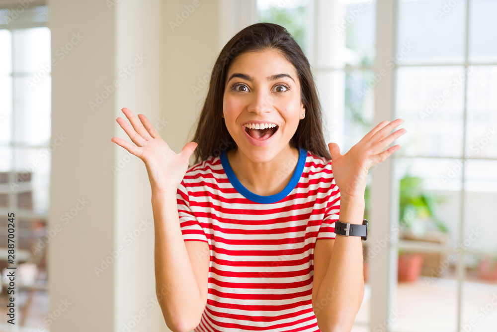 Beautiful young woman celebrating excited for success, screaming and smiling for winning