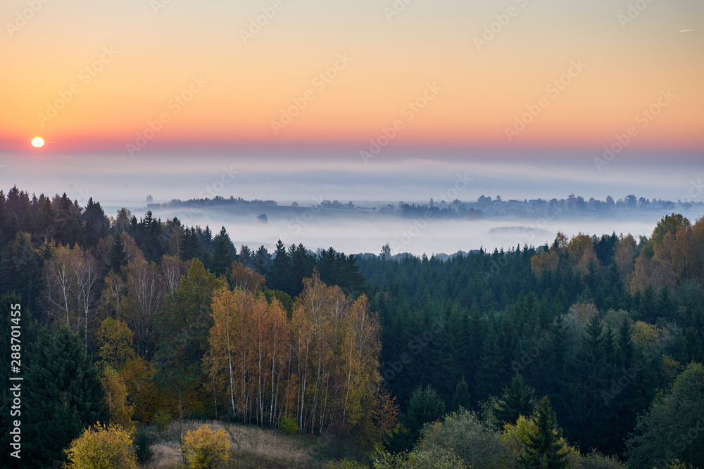 Morning landspace with sun rays. Beautiful landscape with forest and fog.Lithuanian landscape.