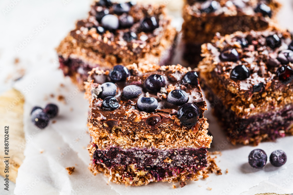 Raw vegan coconut chocolate dessert with blueberries . Healthy vegan food concept. Raw vegan coconut chocolate dessert with blueberries . Healthy vegan food concept.