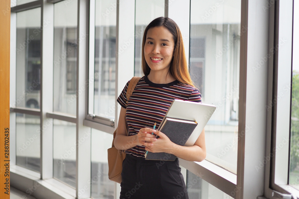 Beautiful female student with a book in high school or university Beautiful female student with a book in high school or university
