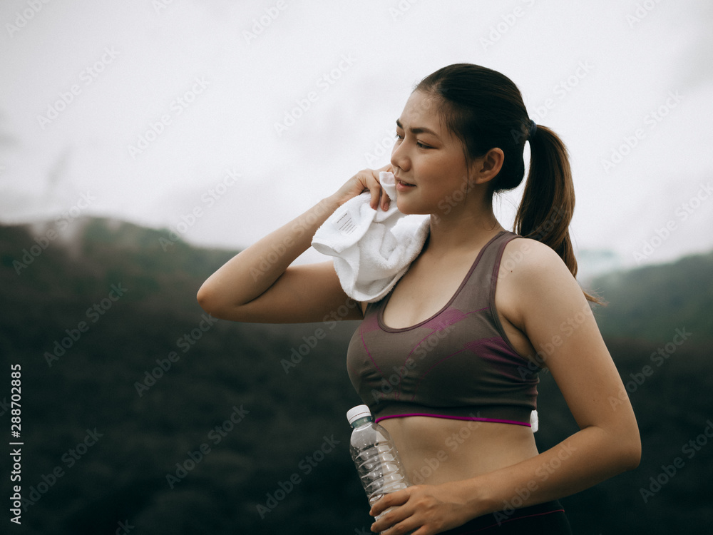 Asian woman look smart and healthy exercise outdoor in morning time Asian woman look smart and healthy exercise outdoor in morning time