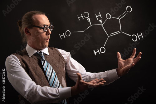 Professor presenting handdrawn chemical formula of Vitamin C