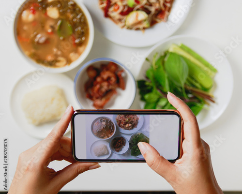 taking photo of thai food with smart phone