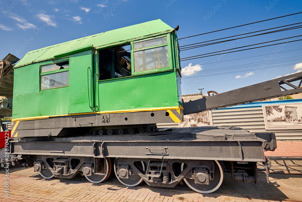 old railway crane at the station near the platform