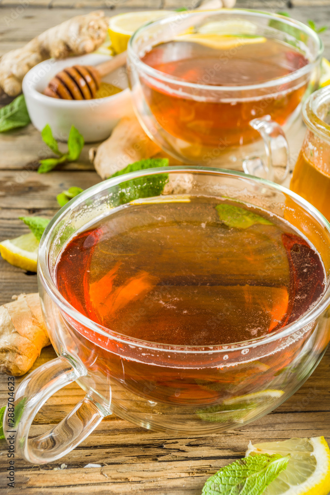 Autumn tea with mint and lemon with ingredients - fresh mint leaves, sliced lemon and honey, rustic wooden background copy space Autumn tea with mint and lemon with ingredients - fresh mint leaves, sliced lemon and honey, rustic wooden background copy space