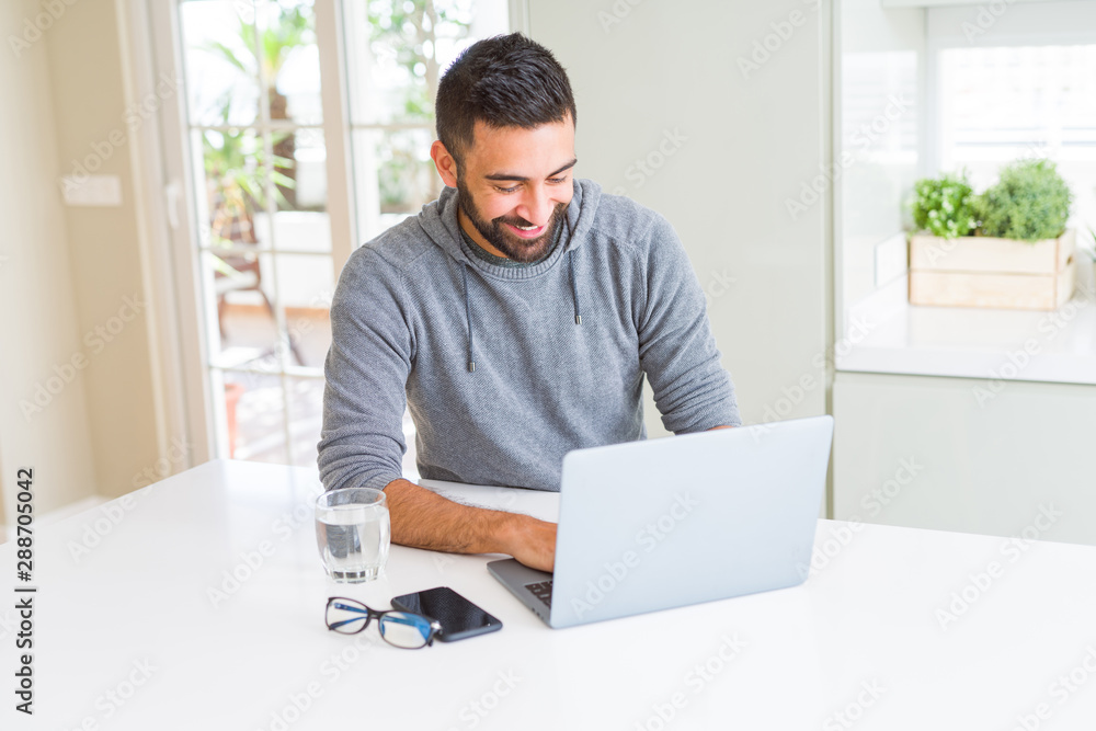 Man smiling working using computer laptop Man smiling working using computer laptop