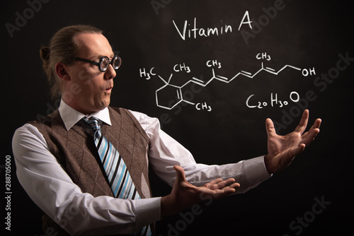 Professor presenting handdrawn chemical formula of Vitamin A