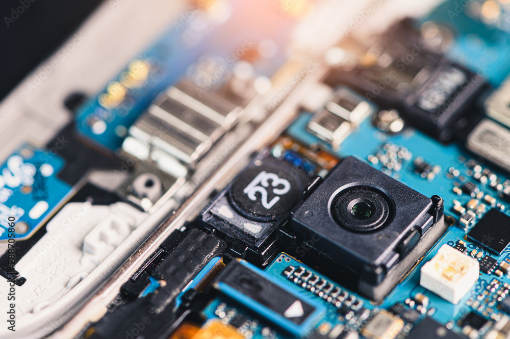 The inside of the smartphone's motherboard and sim card lay on the back  table. the concept of computer hardware, mobile phone, electronic,  repairing, upgrade and technology. Stock Photo | Adobe Stock