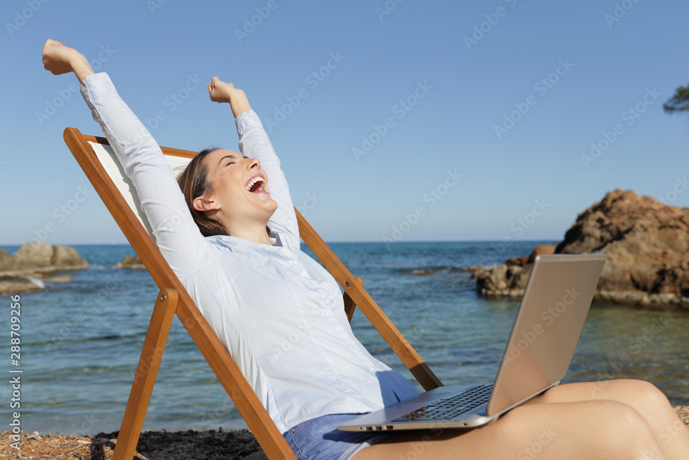 Excited entrepreneur with laptop celebrating success