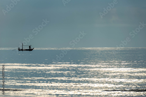 Small wood fishing boat on the sea.