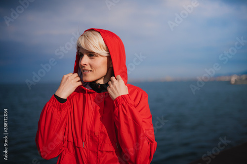 Konstfotografi Front view portrait of young sportswoman standing outdoors on beach