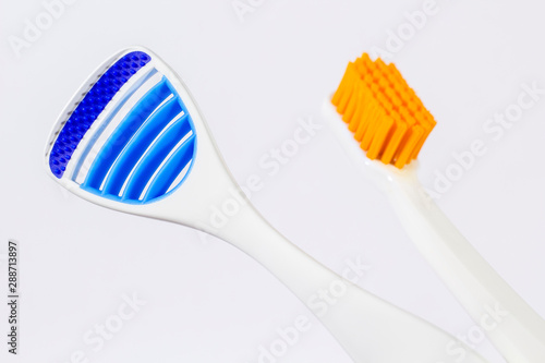 Toothbrush and tongue scraper