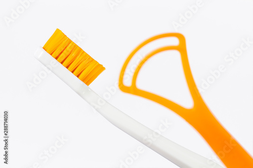 Toothbrush and tongue scraper