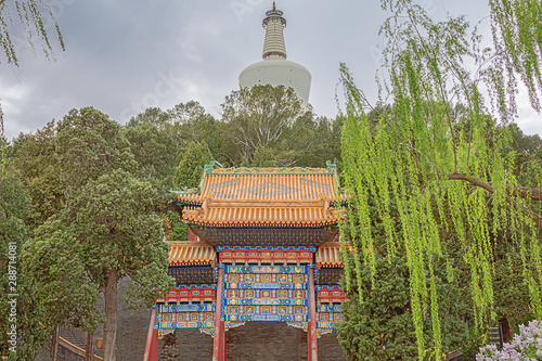 Standing in front of the White Pagoda on Qionghua Island in Beihai Park in Beijing
