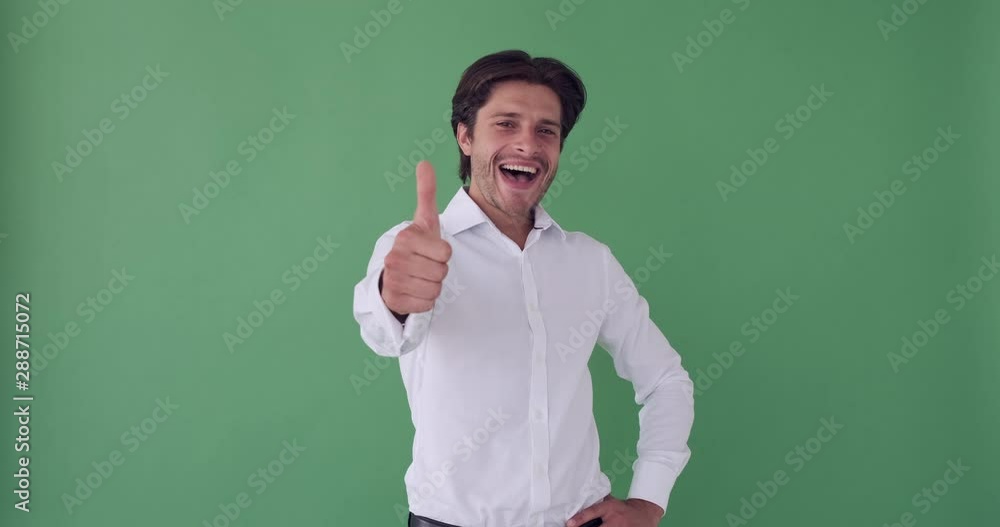 Happy businessman giving thumbs up gesture over green screen Happy businessman giving thumbs up gesture over green screen