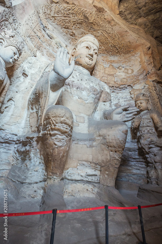Weathered Buddha statue in cave 3 of the Yungang Grottoes near Datong