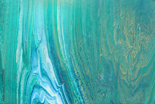 art photography of abstract marbleized effect background. turquoise, emerald green, blue and gold creative colors. Beautiful paint.