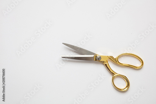 Foto Scissors gold and silver isolated against white background