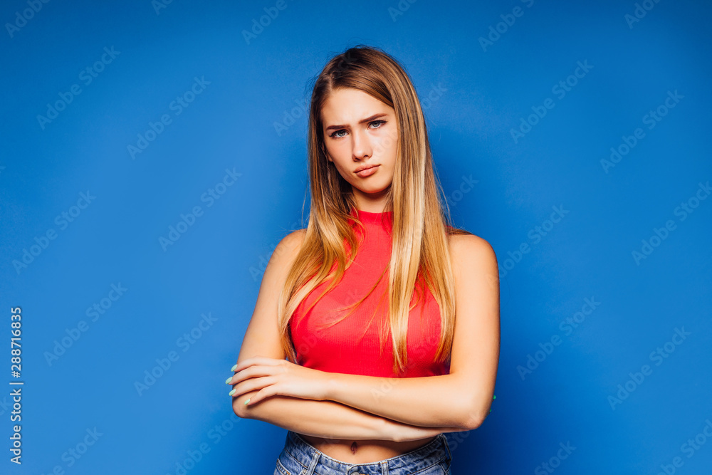Portrait of young woman stay on blue background with shocked facial expression. Portrait of young woman stay on blue background with shocked facial expression.