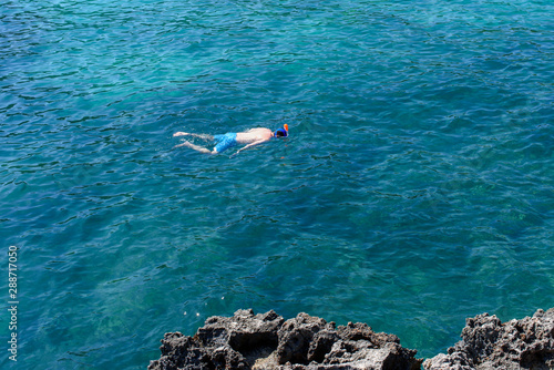 Diver or snorkeler at Mediterranean sea during his vacations.