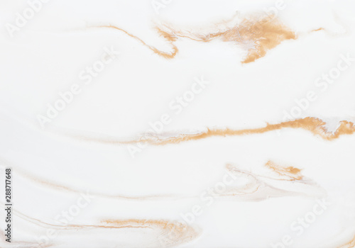 photography of abstract marbleized effect background. gold and white creative colors. Beautiful paint.