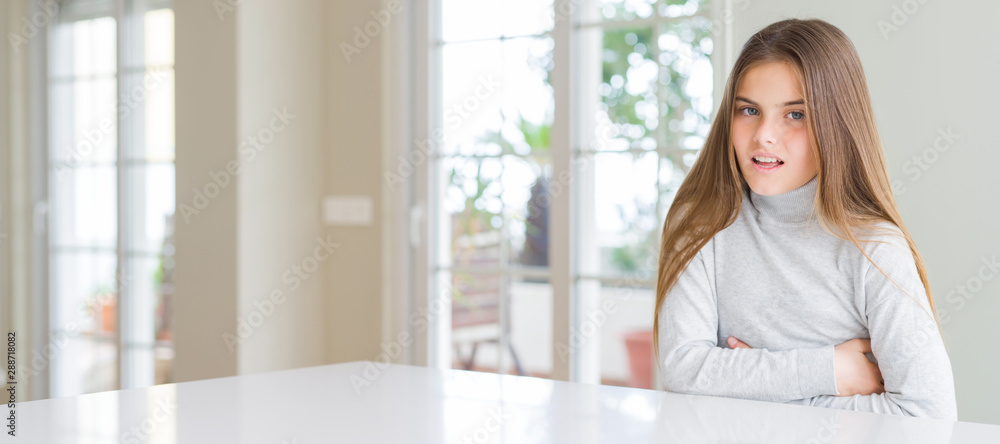 Wide angle picture of beautiful young girl kid wearing casual sweater with hand on stomach because nausea, painful disease feeling unwell. Ache concept. Wide angle picture of beautiful young girl kid wearing casual sweater with hand on stomach because nausea, painful disease feeling unwell. Ache concept.