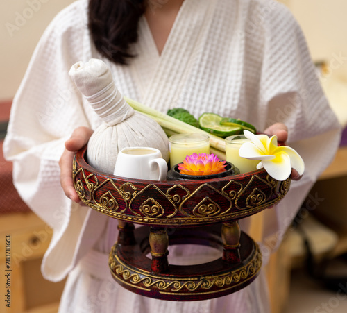 Towels with salft spa and candles for relax spa massage and body treatment. Thai herbal spa and wellness elements setting for traditional Thai massage, tropical spa treatment background concept. photo