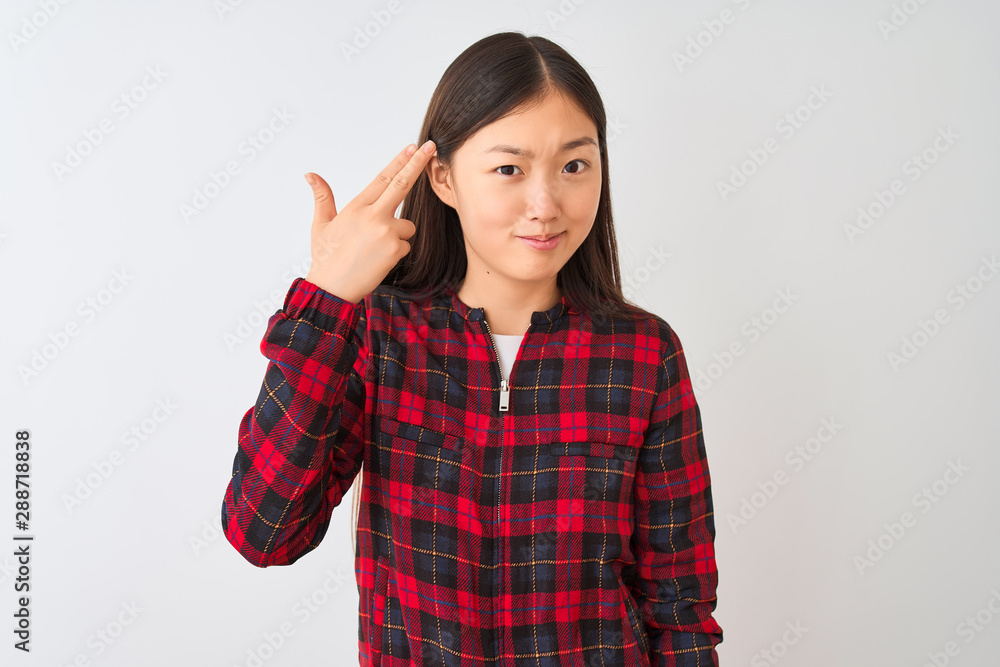 Young chinese woman wearing casual jacket standing over isolated white background Shooting and killing oneself pointing hand and fingers to head like gun, suicide gesture. Young chinese woman wearing casual jacket standing over isolated white background Shooting and killing oneself pointing hand and fingers to head like gun, suicide gesture.