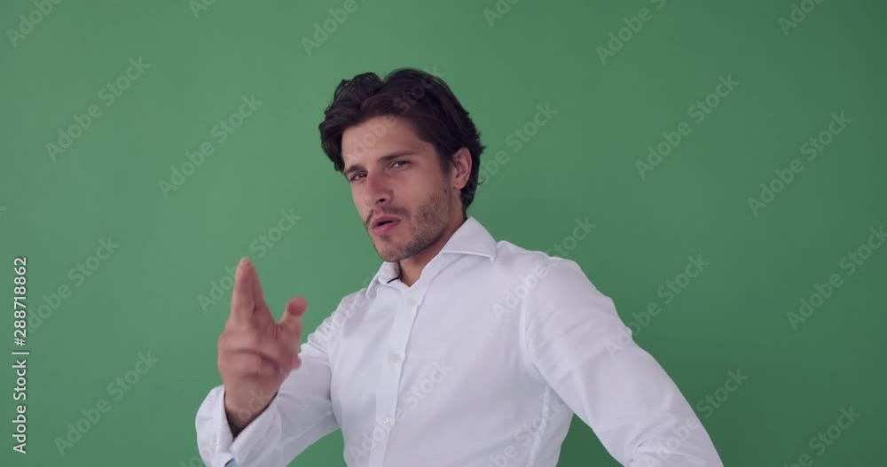 Young businessman turning around and gesturing to shoot with air gun Young businessman turning around and gesturing to shoot with air gun