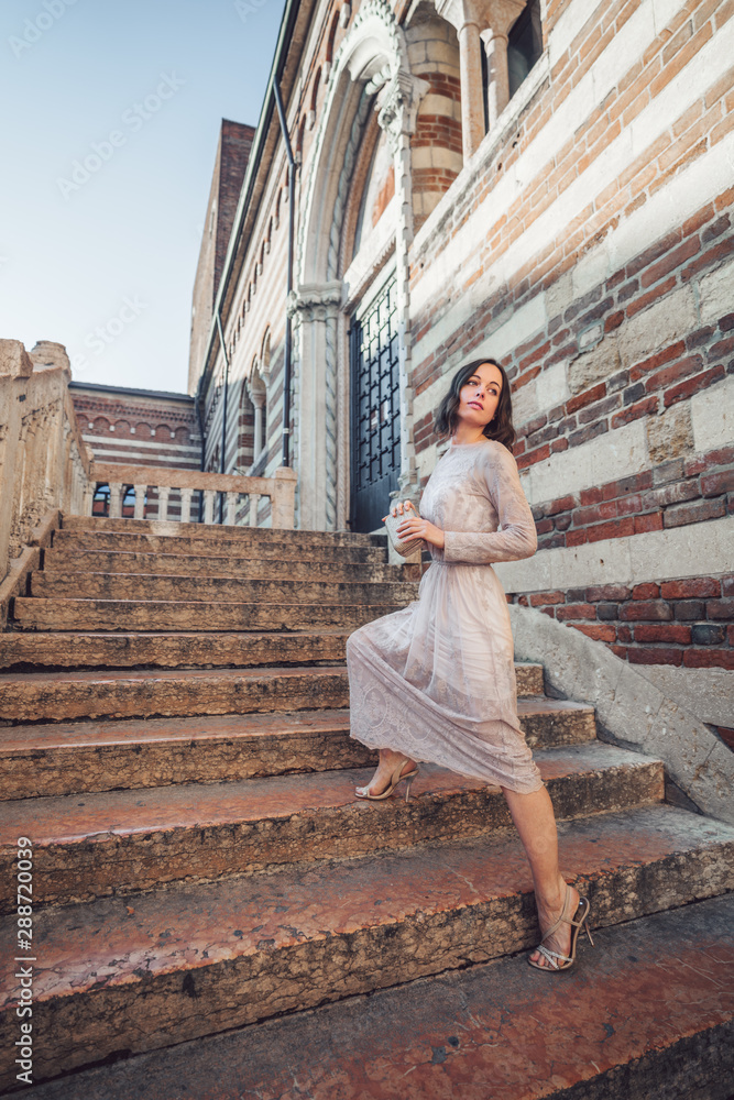 Young girl in a beautiful dress on the stairs Young girl in a beautiful dress on the stairs
