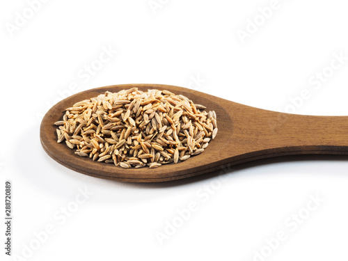 Cumin seeds (Cuminum), Jeera in wooden spoon on a white background horizontally