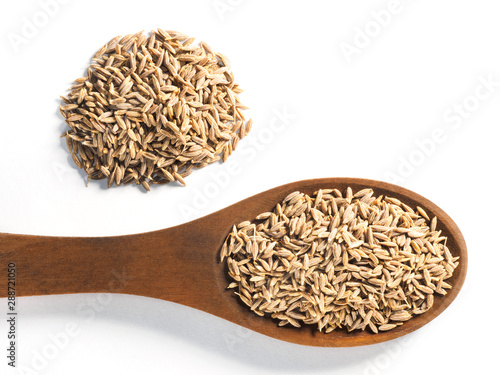 Cumin seeds (Cuminum), Jeera in wooden spoon on a white background horizontally
