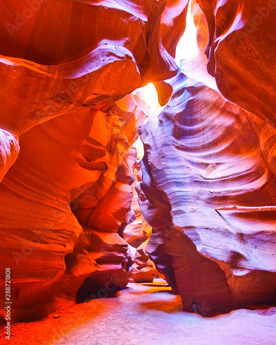 View of Upper Antelope Canyon with sunbeam shined into canyon at noon in early October in Arizona, USA.