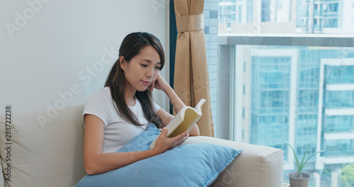 Woman reads a book at home