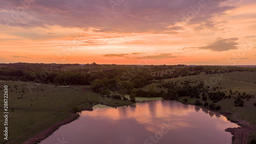 Sunrise over rural Nebraska wetland and stock pond