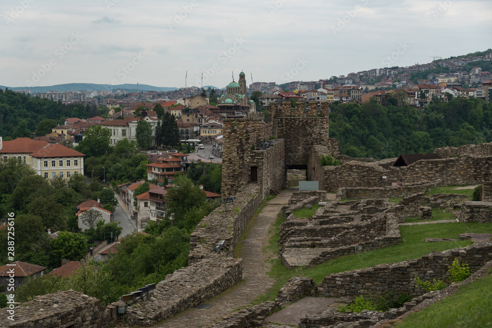 Gate tower and ruins of Tsarevets fortress with a view of the old town of Veliko Tarnovo in the background, Bulgaria