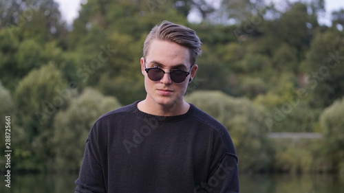Cool guy with sunglasses looking into the camera