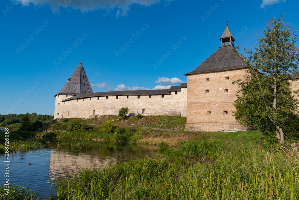 View to Elena river, Gate Tower and Strelochnaya Tower of the old medieval Old Ladoga Fortress in Russia View to Elena river, Gate Tower and Strelochnaya Tower of the old medieval Old Ladoga Fortress in Russia