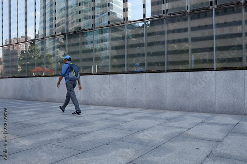 Man walking in front of a building © Alberto