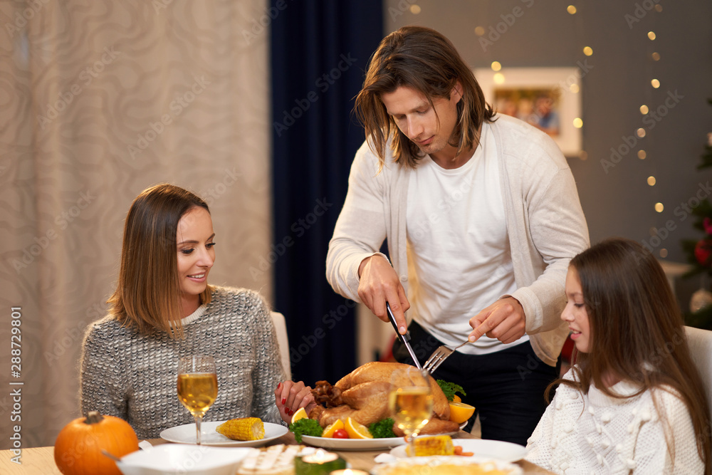 Beautiful family eating Christmas dinner at home
