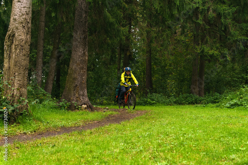 equipped cycling tourist on a trail in the forest