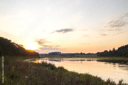 Sunset by the river in the summer countryside © Andrey