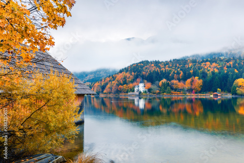 Foggy autumn view of Grundlsee lake. Romantic morning scene of Brauhof village, Styria stare of Austria, Europe. Colorful view of Alps. Traveling concept background. Orton Effect.