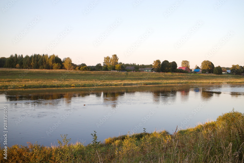 by the river in the countryside on a summer evening by the river in the countryside on a summer evening