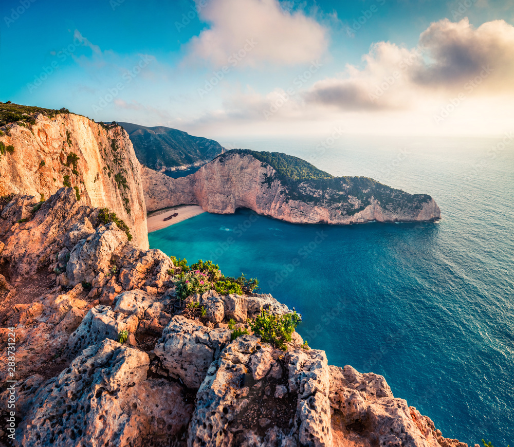 Fantastic spring voew of the Shipwreck Beach. Colorful sunset on the Ionian Sea, Zakinthos island, Greece, Europe. Beauty of nature concept background. Artistic style post processed photo.