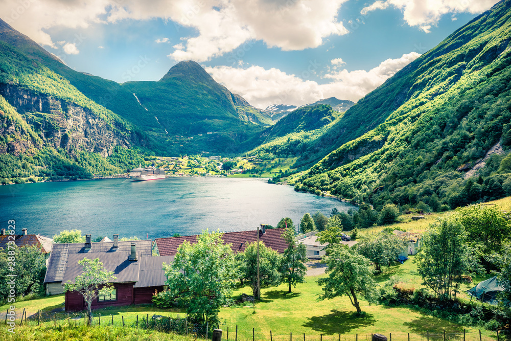 Beautiful summer scene of Geiranger port, western Norway. Sunny view of Sunnylvsfjorden fjord. Traveling concept background. Instagram filter toned.