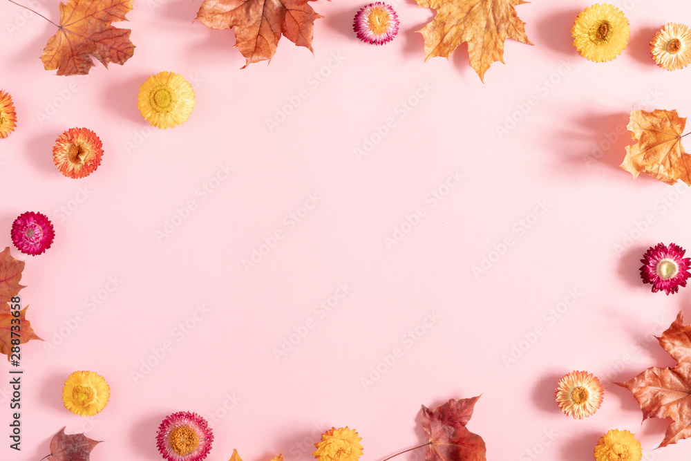 Autumn creative composition. Beautiful colorful flowers, leaves on pastel pink background. Fall concept. Autumn background. Flat lay, top view, copy space