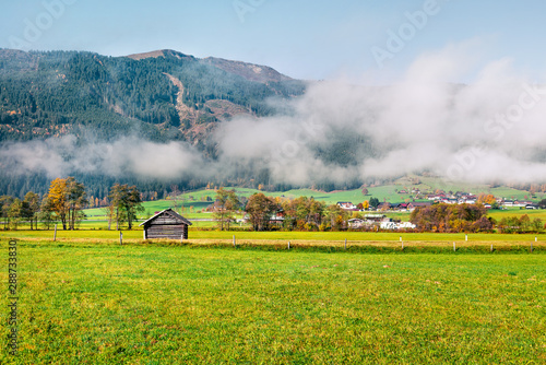Sunny morning view of Mitterhofen village in the district of Zell am See in the Austrian state of Salzburg. Colorful autumn scene of Alps, Austria, Europe. Traveling concept background.